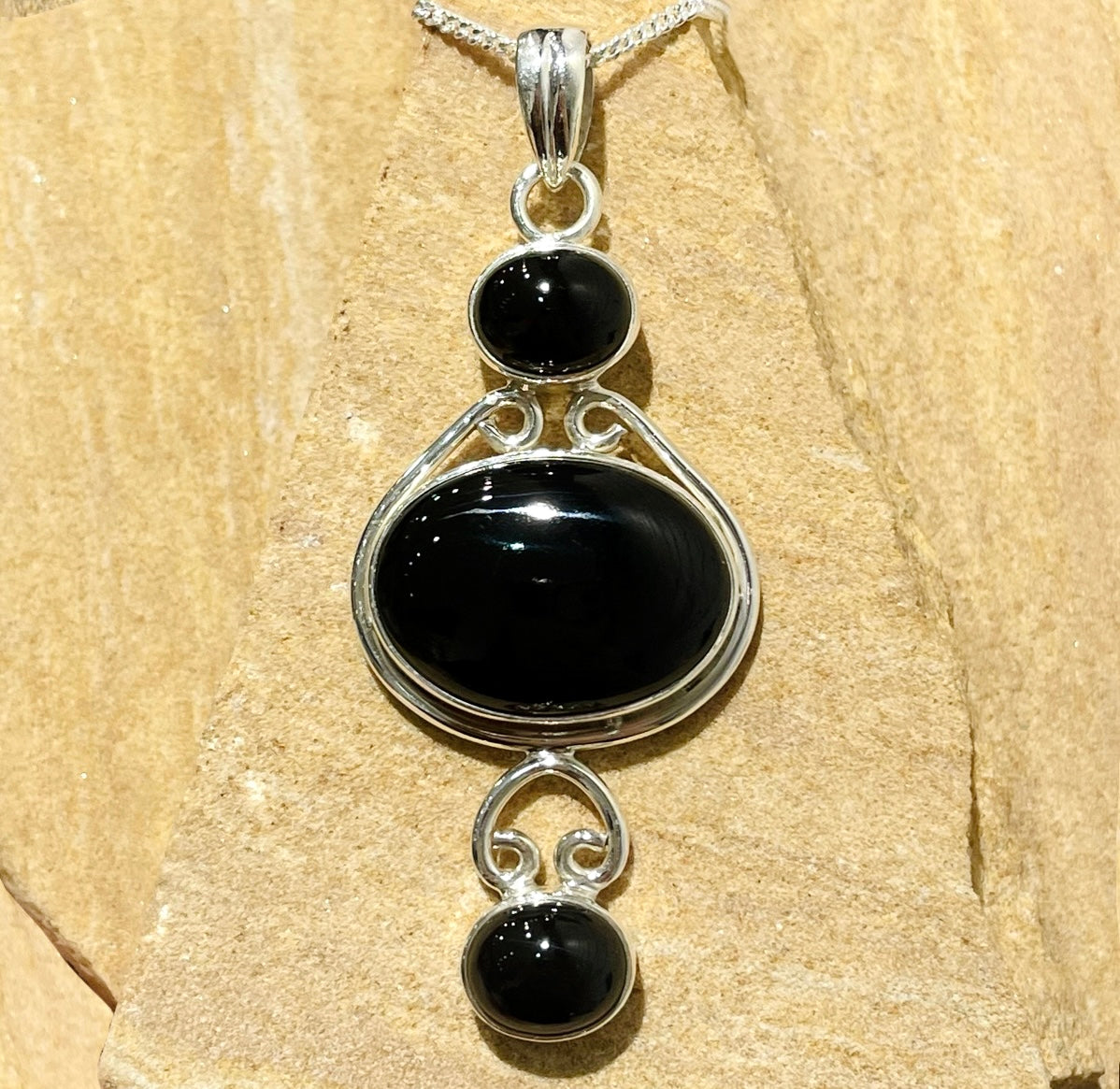 Obsidian three stone pendant in sterling silver